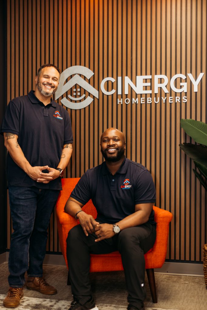 The founders of Cinergy Homebuyers, a trusted cash home buyer in Cincinnati & Northern Kentucky, pose for a photograph in their office.