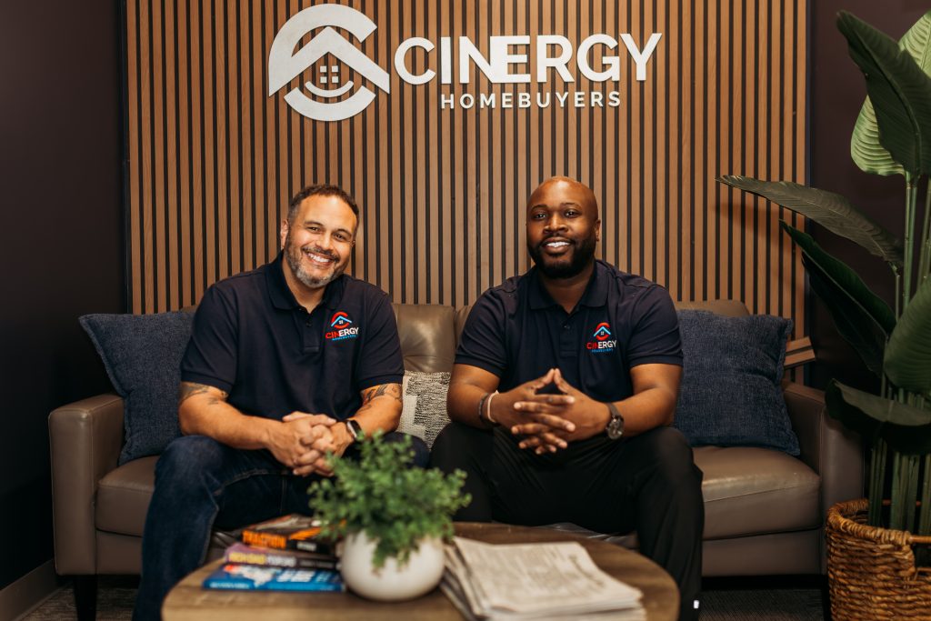 Learn more about Cinergy Homebuyers, a trusted cash home buyer in Cincinnati & Northern Kentucky. The founders of Cinergy Home Buyers pose for a photograph in their office. We make selling your home simple with quick, stress-free cash offers and an easy process.