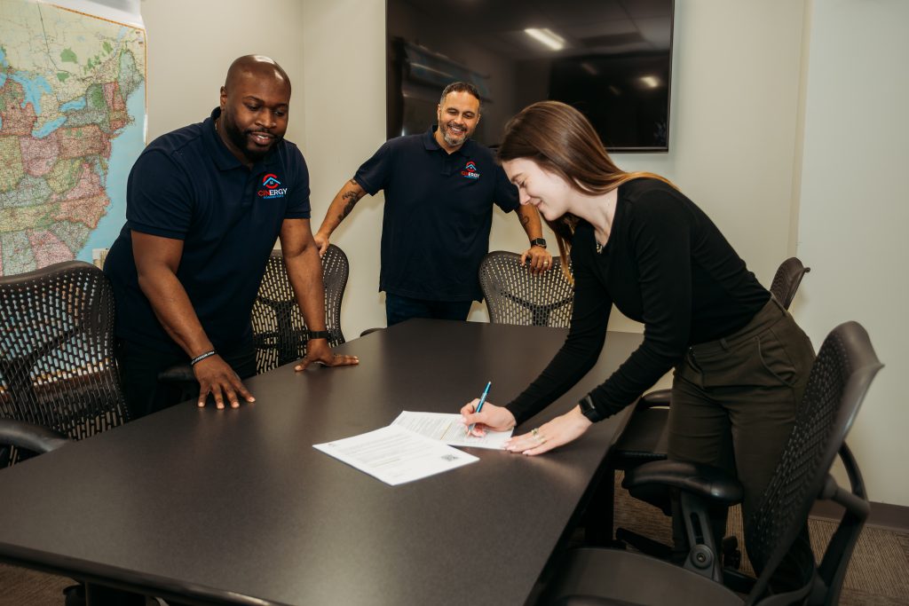 Sell your house fast for cash in Cincinnati & Northern Kentucky with Cinergy Homebuyers. The founders of the company watch as a customer signs a quick, hassle-free cash offer for her home.